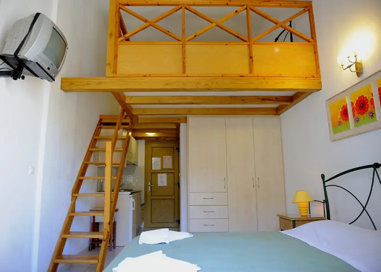 The loft above the beds, reached by a wooden stair