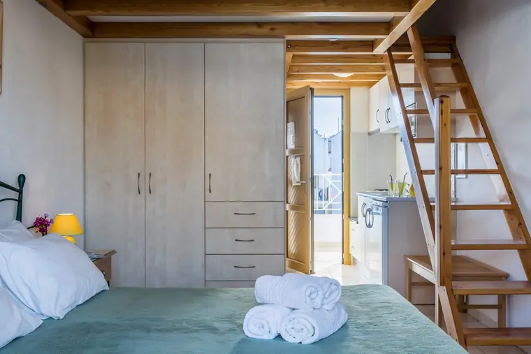 A wardrobe and the ladder to the loft