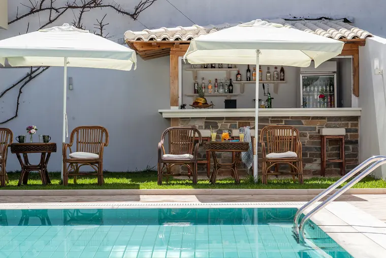 The pool bar under its tiled roof, across the pool
