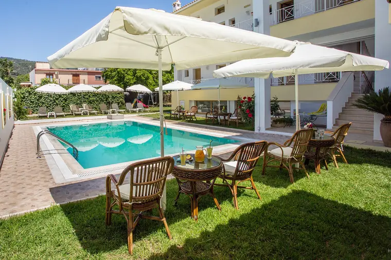 The pool, umbrellas and garden chairs on a sunny day