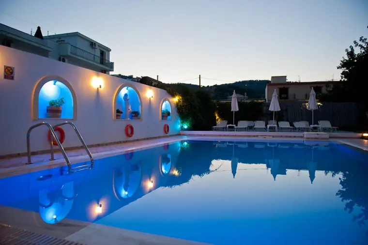 The pool at dusk, its arched niches lit up