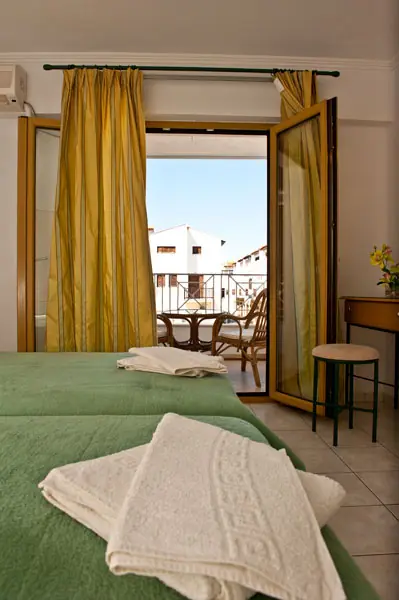 The balcony door open beside the bed