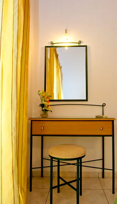A dressing table and mirror by the window